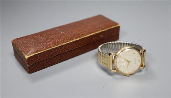 A Garrard 9ct gold-cased presentation wristwatch, with cream Arabic dial and subsidiary seconds, on expanding metal bracelet